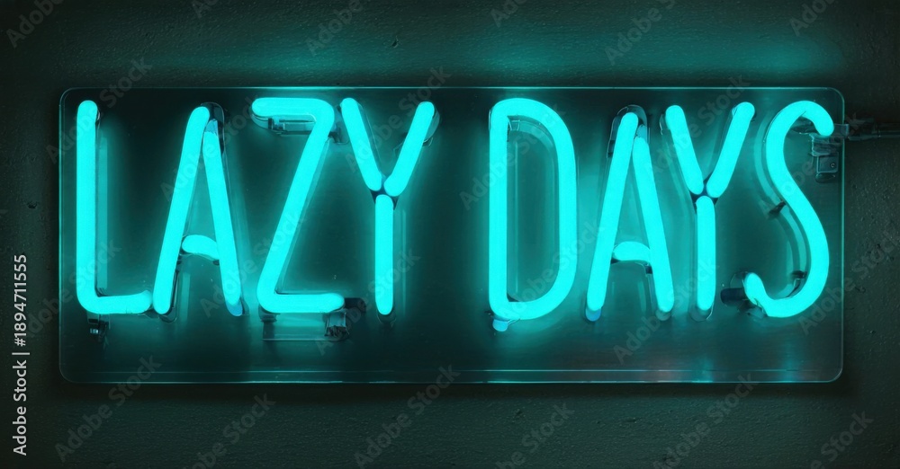 Obraz premium Bright neon sign displays Lazy Days. Turquoise glow contrasts dark background. Simple lettering creates modern aesthetic. Relaxed vibe.