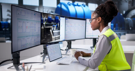 Young Female Engineer Optimizing Industrial Systems