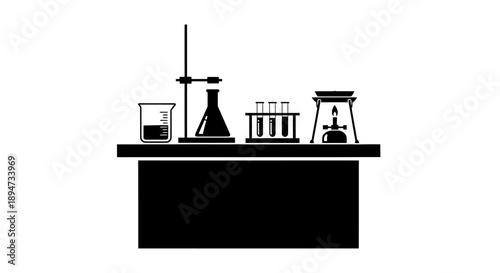 Laboratory equipment on a table with a Bunsen burner.