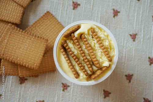 Trendy viral Japanese yogurt cheesecake with cookies biscuit. Preparation of tasty no bake dessert treat at home