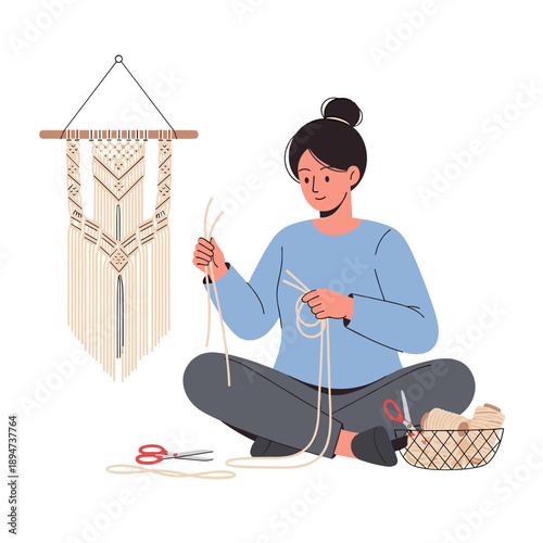 Woman crafting macrame wall decor while sitting on the floor  