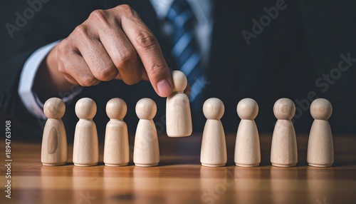 Businessman selecting individual from group of wooden people