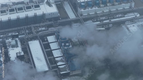 Aerial view of data center cooling system emitting steam during winter