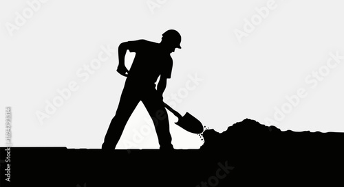 Silhouette of a construction worker digging with a shovel.