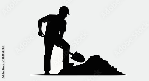 Silhouette of a construction worker digging with a shovel.