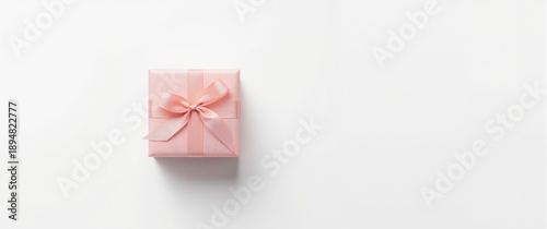 Ribbon-tied pink gift box with bow