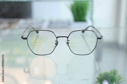 Eyeglasses on table, progressive lenses, eyeglasses for the elderly, glasses progressive lens, eyeglass progressive lens, close-up of glasses on lenses test, looking through glasses