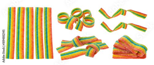 Quadro su tela a curated arrangement of rainbow sour belt candies, featuring straight strips, coiled shapes, and knotted pieces on a black backdrop