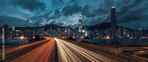 Bottom Angle View of Highway Car Light Trails Against Hong Kong's Modern Urban Skyline