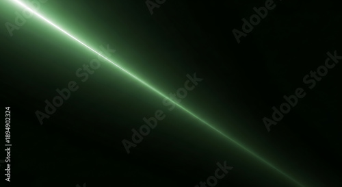 A single, vibrant green glowing light beam shoots diagonally across a stark black background, symbolizing focus, energy, and precision.