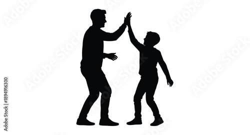 Silhouette of a father and son giving each other a high five