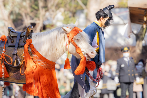Sacred white horse and shinto priest performing Aouma Shinji (White Horse Rite) at Sumiyoshi Taisha shrine, Osaka, Japan