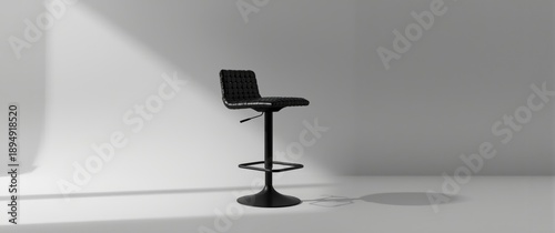Swivel bar stool in black with woven leather seat against gray backdrop