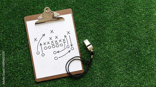 Coach clipboard with tactical game plan diagram and whistle
