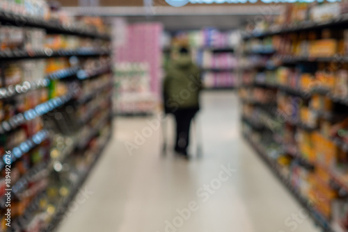 Wallpaper Mural Shopper navigating grocery store aisle with shopping cart Torontodigital.ca