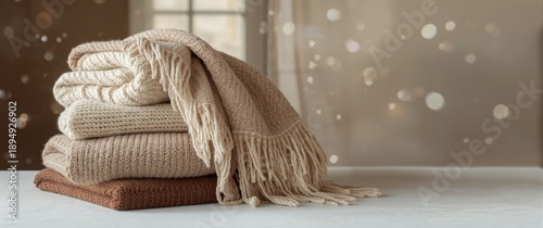 Different beige and brown woolen blankets piled together