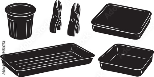 Black kitchen utensils and baking pans on white background