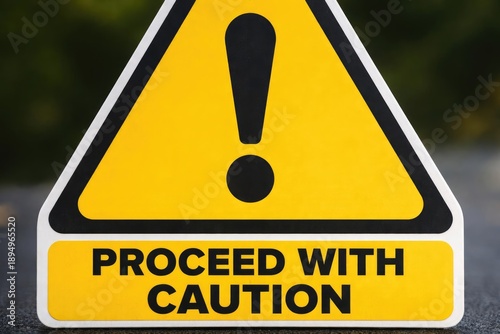 Zoomed in photo of a warning emblem featuring exclamation point urging motorists to proceed with caution