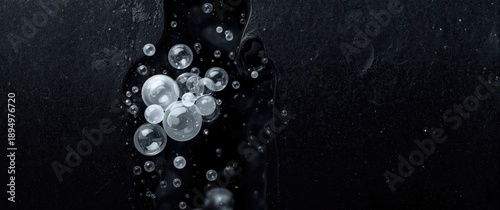 Collection of white soap bubbles, shampoo or shower gel against black background, textured and contrasting, bath and shaving cream foam