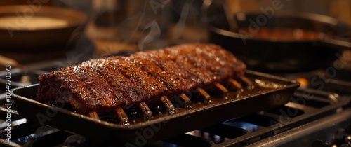 Cast iron tray with dry rub pork ribs baked and resting on the stove top