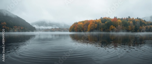 Soft rain drapes a calm lak...