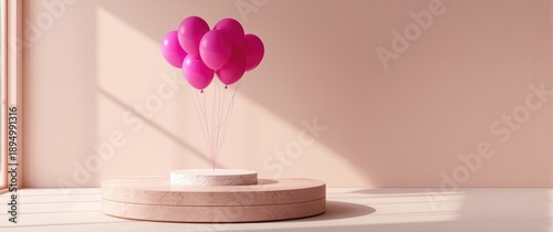 Empty table with pink ballo...