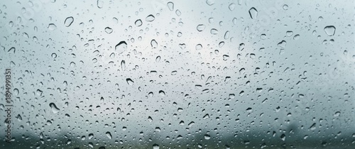 Raindrops on car glass used as wallpaper background with pattern, abstract design, texture, water, sky, nature, light, white, blue