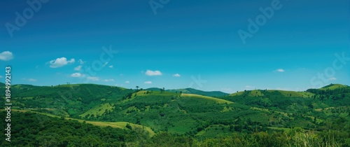 Green hills stretching bene...