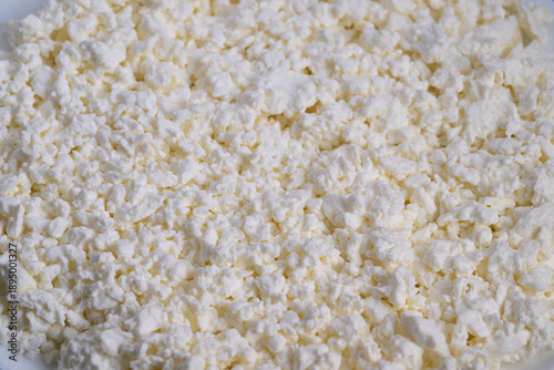 Obraz na plátně Closeup curd cheese mass showing crumbly white clusters, artisan cheesemaker ins