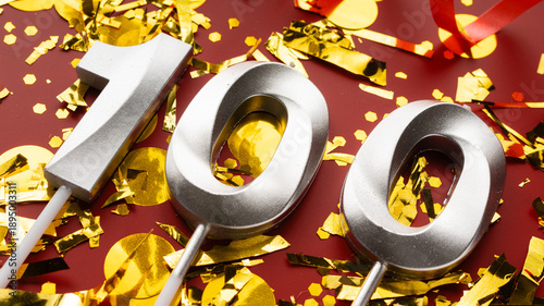 Obraz na płótnie Number 100 celebration birthday digit on Red festive with confetti background