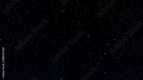 Foto Abstract night sky with falling stars and drifting snowflakes in a dark cosmic s