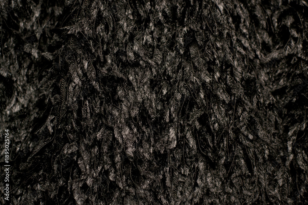 Fototapeta premium Close-up of black feather fabric. Fabric texture: feathers.