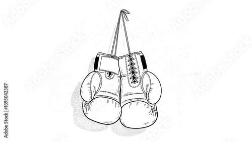 Monochrome boxing gloves hanging on wall