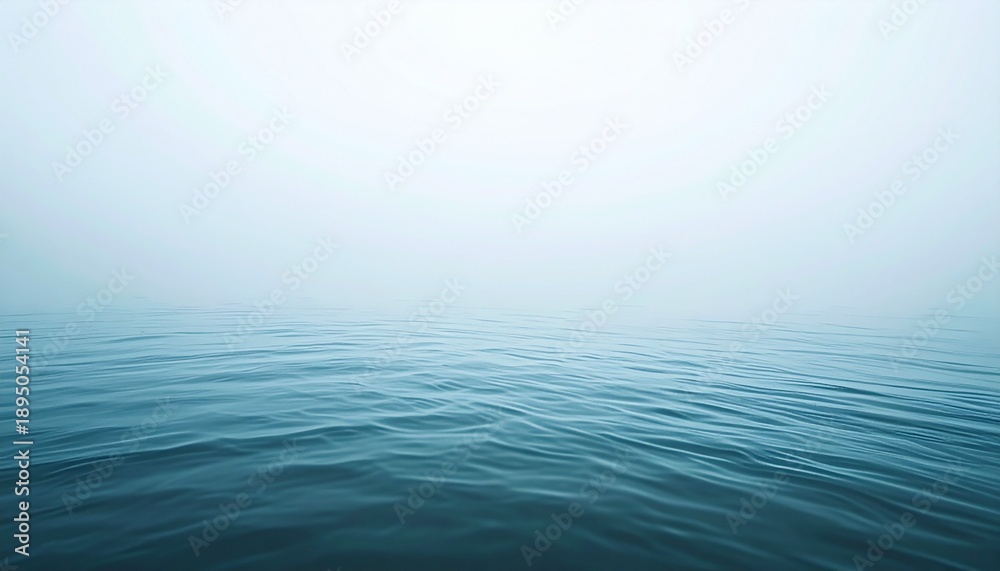 Fototapeta premium Calm Ocean Waters Under a Misty Sky - A Serene Landscape.