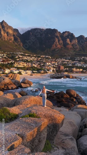 A serene late afternoon view of Cape Town's coastline, featuring Table Mountain and a tranquil beach setting