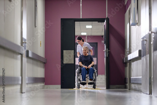 Fotografija Senior Caucasian woman with disability sitting in wheelchair being assisted by y