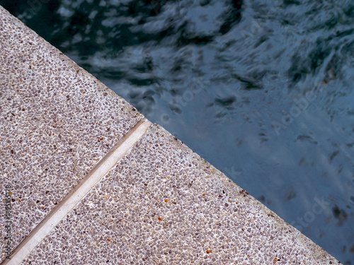 The straight lines and triangle shapes of water at the corners of the swimming pool