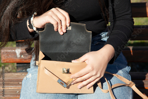 woman with stylish handbag on city street