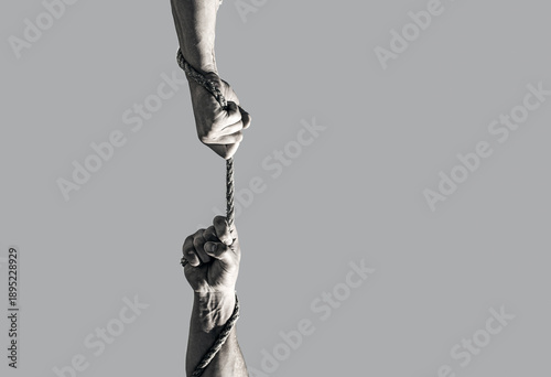 Hand hold in rope connecting for concept teamwork. Hand holding a rope, climbing rope. Black and white