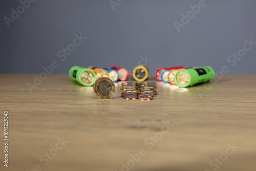 New collection of Bulgarian euro cents photographed on a wooden table. Colorful vertical columns with coins in denominations: 5, 10, 20, 50 cents and 1 euro. Selective focus and close-up.