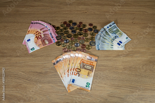 New collection of euro cent coin sets isolated on wooden background, European Union 2026. Colorful columns with coins in denominations: 5, 10, 20, 50 cents, 1, 2 euros and paper 5, 10, and 50 euros. B