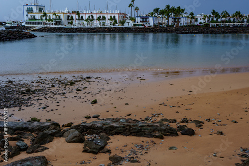 Konstfotografi Rocky shoreline and calm bay near coastal town