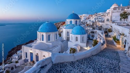 Santorini Island at Dusk: Iconic Blue-Domed Churches and Whitewashed Buildings Overlooking the Aegean Sea