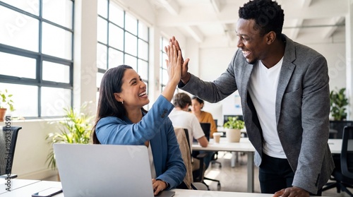 Smiling Colleagues High Fiving at Work