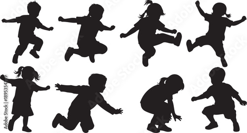 Silhouettes of happy children playing and jumping together freely