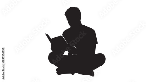 A man sits cross-legged on the floor reading a book in a serene and quiet environment from a front viewpoint