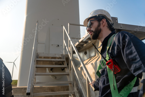Male wind turbine engineer working in windmill station