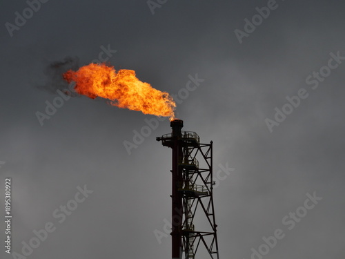   refinery fire gas torch on sky background