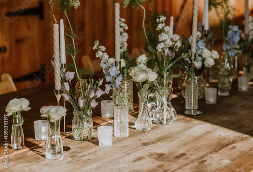 Flowers in vases and candles diaplyed for  wedding decor