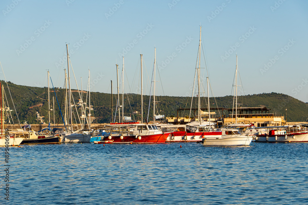 Obraz premium Yachts in the port of Herceg Novi, Montenegro. Bay of Kotor, Adriatic Sea. A wonderful tourist destination. A beautiful summer sunset.